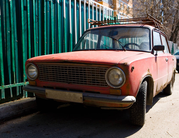 Parked old rusty red Soviet car.  - Foto, Bild