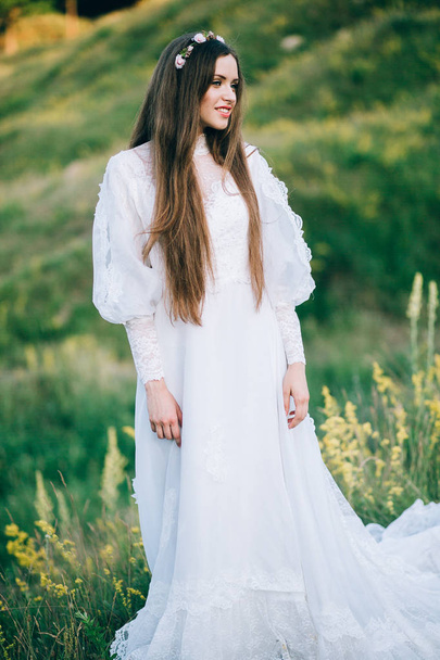 young  beautiful  bride posing outdoors - Фото, изображение