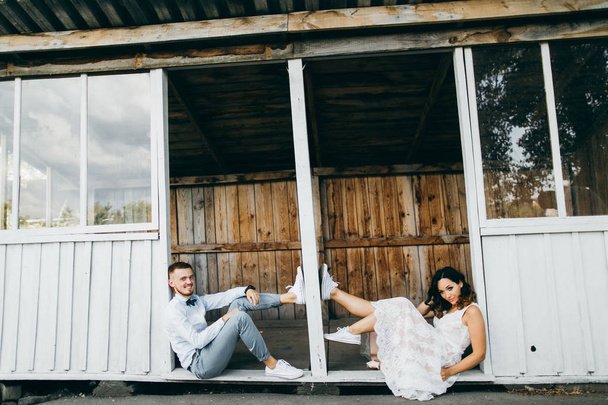 Beautiful young  couple posing by old house - Photo, Image