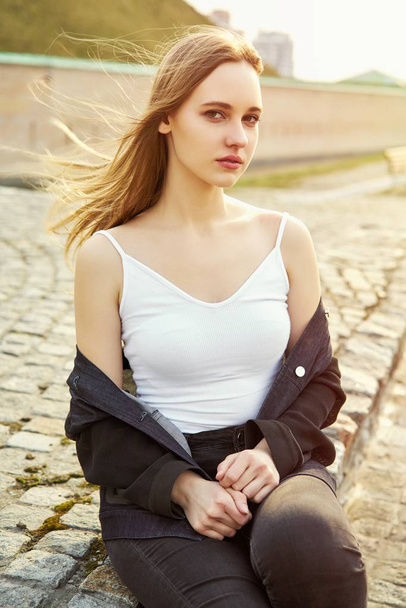 Pretty young woman in casual clothes posing on the street                  - Fotografie, Obrázek