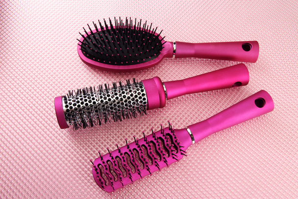 Comb brushes on pink background - Fotó, kép