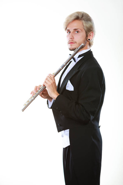 Male flutist wearing tailcoat holds flute - Zdjęcie, obraz