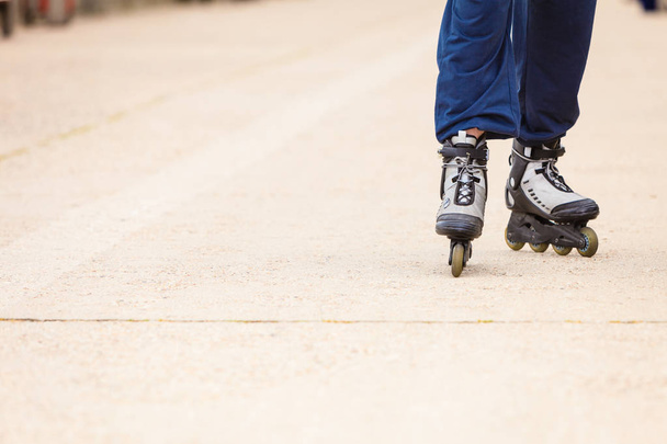 Human legs rollerblading wearing sportswear. - Photo, image