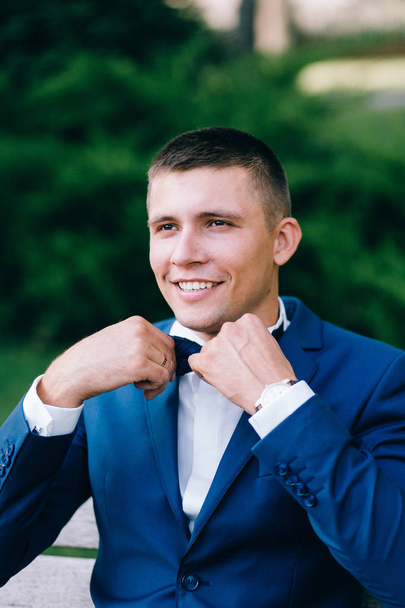 handsome  young groom  posing outdoors - Photo, Image