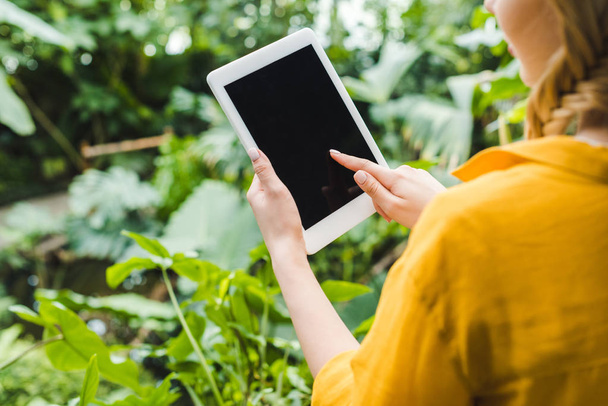 cropped shot of young woman using digital tablet outdoors - Photo, image