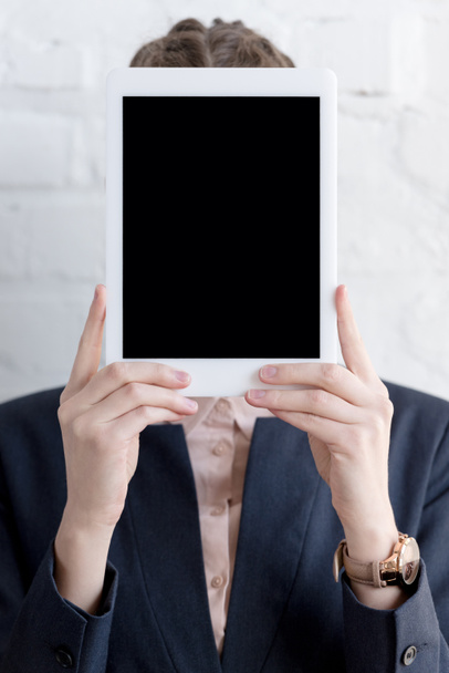 businesswoman in suit holding digital tablet with copy space - Fotó, kép