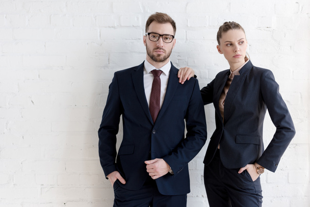 confident business coworkers posing together near white wall - Foto, imagen