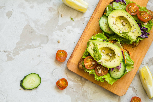 dietary sandwiches with avocado and salad for breakfast  - Фото, зображення