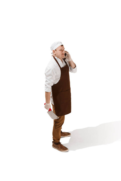 Smiling butcher posing with a cleaver isolated on white background - Φωτογραφία, εικόνα