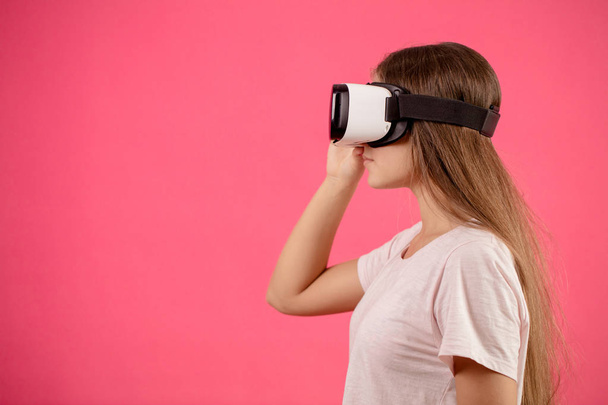 close up profile young female with virtual reality goggles on the head - Фото, изображение