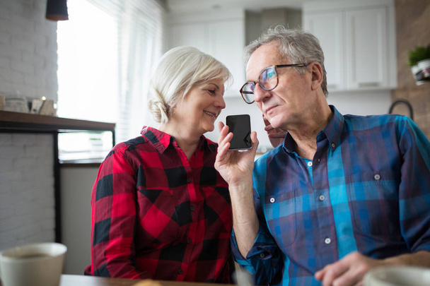 Senior couple having phone conversation together - Fotó, kép