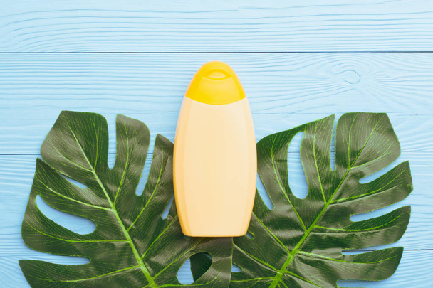Sunscreen cream bottle on blue - Фото, зображення