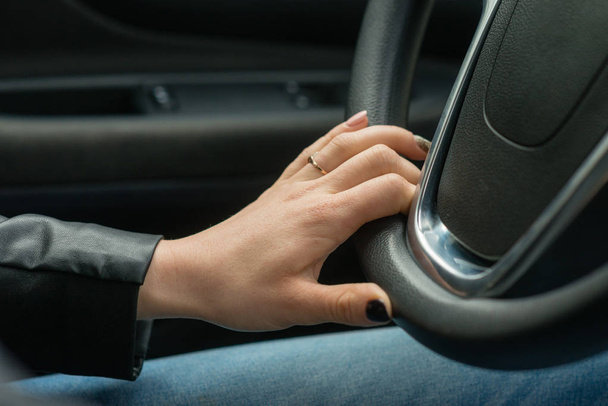Women hands on the car's steering wheel. - Φωτογραφία, εικόνα