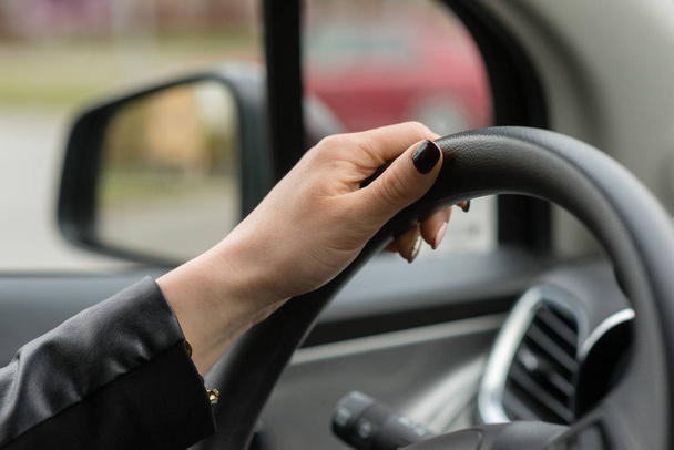 Women hands on the car's steering wheel. - Foto, Imagem