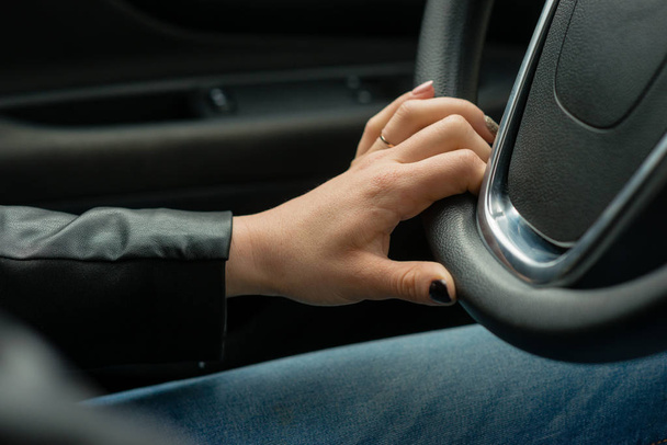 Women hands on the car's steering wheel. - Foto, Imagem