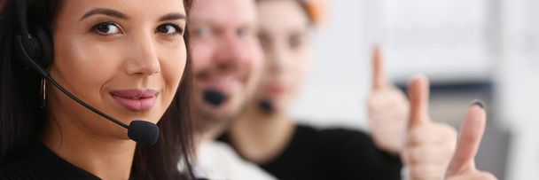 Three call centre service operators arm show OK - Photo, Image