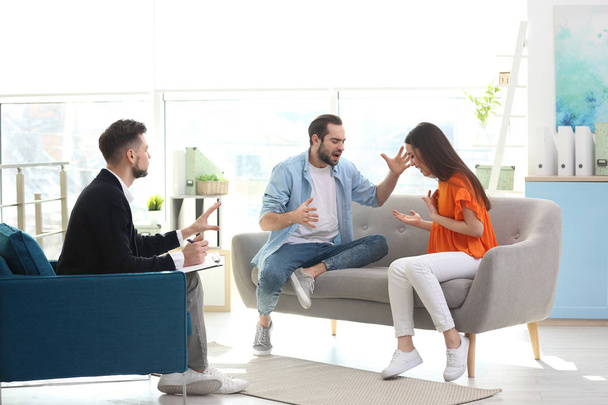 Family psychologist working with young couple in office - Foto, Bild