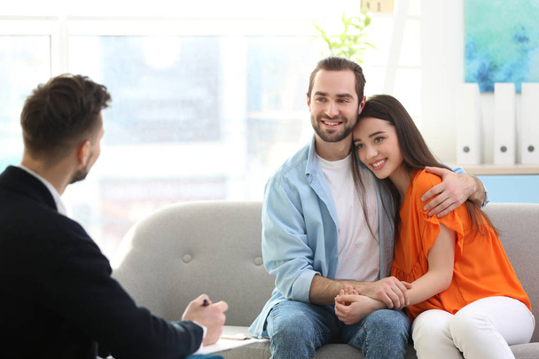Family psychologist working with young couple in office - Foto, imagen