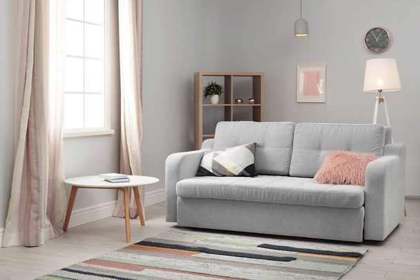 Modern living room interior with comfortable sofa and beautiful carpet - Фото, изображение
