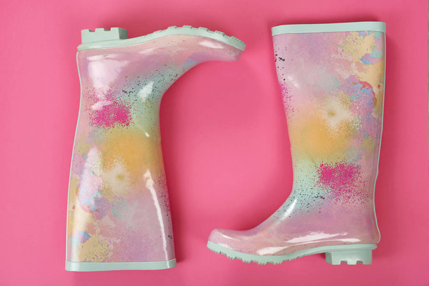 Pair of gumboots on color background, top view. Female shoes - Φωτογραφία, εικόνα