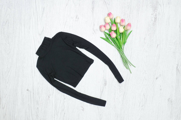 Black turtleneck, bouquet of tulips. Fashionable concept - Photo, Image
