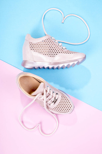 Pink Women's sneakers on a color background - Photo, Image