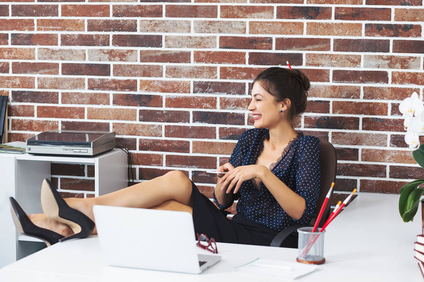Izgatott a nevető üzleti nő ül egy modern irodában - Fotó, kép