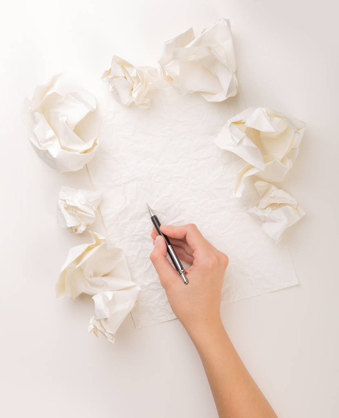 Writing hand in crumpled paper - Фото, изображение