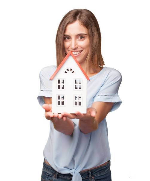 young pretty woman holding a small house  - Фото, изображение
