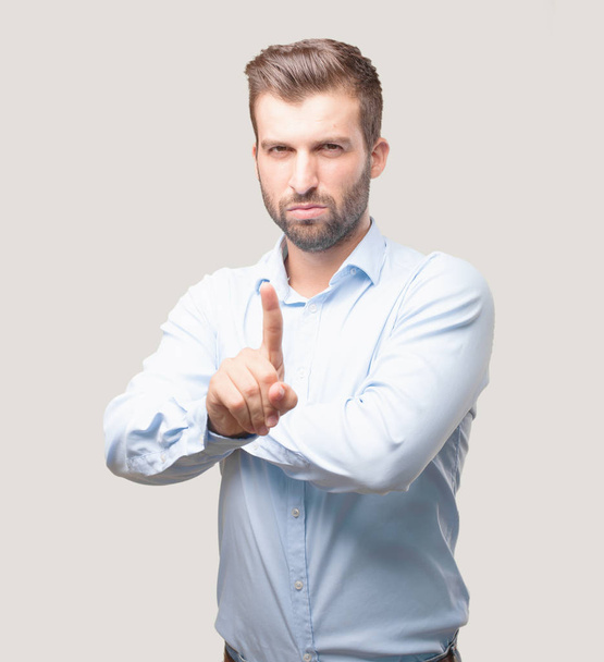 Young handsome man disagree and angry expression wearing a blue t shirt. Person isolated against monochrome background. - Foto, Imagen