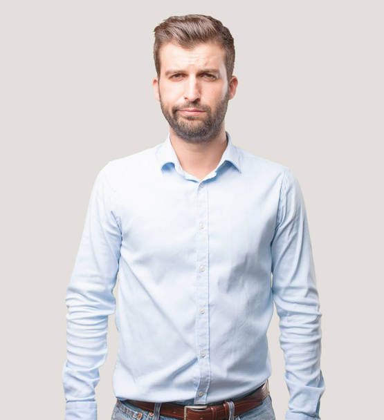 Young handsome man, blue t shirt stressed, disagree expression. Angry concept. Person isolated against monochrome background. - Fotografie, Obrázek