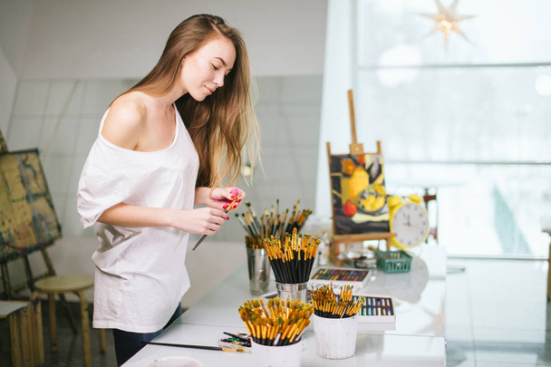 Natural beauty teacher painter in her studio preparing to an art class - Photo, image