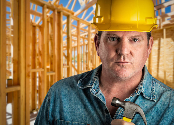 Serious Contractor in Hard Hat Holding Hammer At Construction Site - Photo, Image