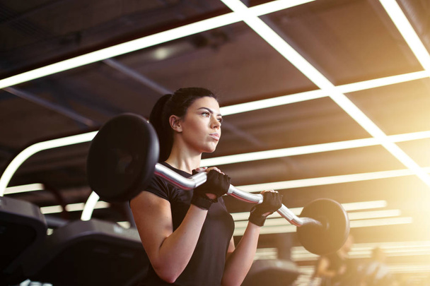 fitness, close up of young woman pick up for biceps in gym - Photo, image