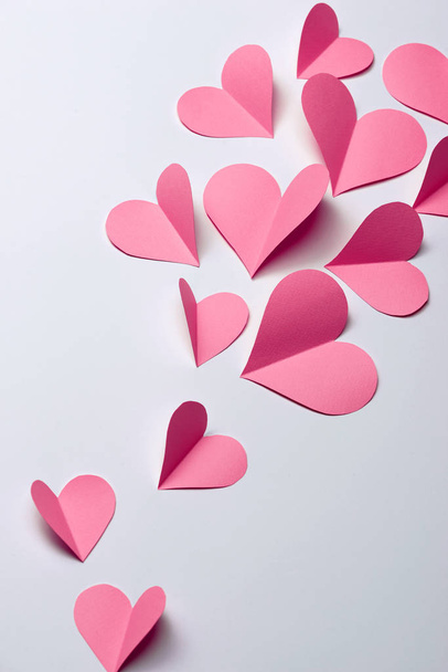 Beautiful pink paper hearts on white paper background  - Foto, Imagen