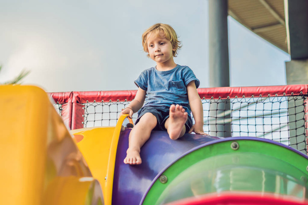 Adorable little toddler boy having fun on playground. - 写真・画像