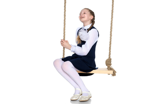 Little girl swinging on a swing - Foto, imagen