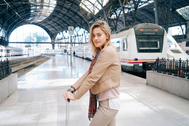 young beautiful modern businesswoman waiting for train at the railway station - 写真・画像