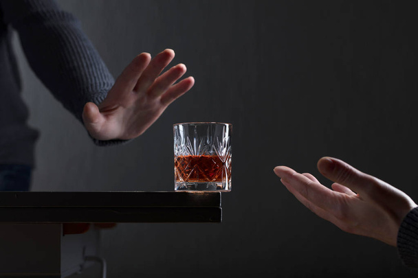 Man with a gesture refuses alcohol.  - 写真・画像