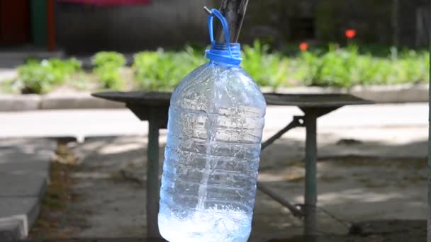 Wlać wodę do butelki z tworzyw sztucznych - Materiał filmowy, wideo