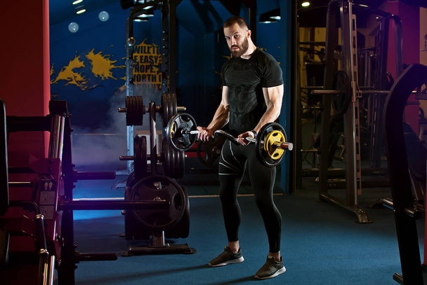 an athlete trains in the gym - Foto, Bild