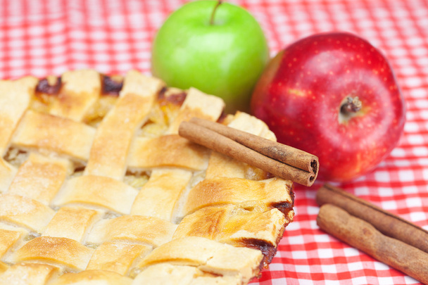 apple pie, apples, cinnamon and almonds on plaid fabric - Photo, Image