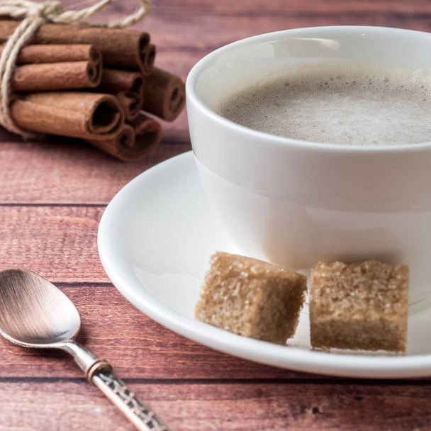 White Cup and saucer Coffee with milk foam and cane sugar cinnamon Anise - Fotoğraf, Görsel