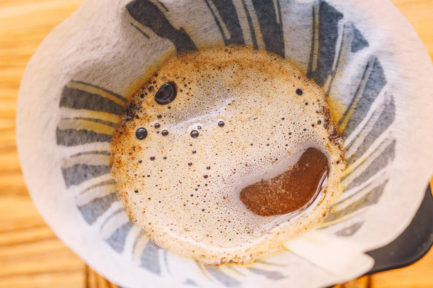 Close up view of brewing cup with coffee - Fotó, kép