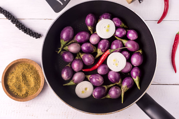 Organic Raw Baby Indian Eggplants in a Pan Top View Flat Lay Raw Eggplants Wooden Background - Photo, Image