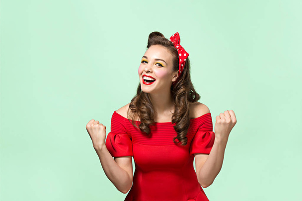 Beautiful young woman with pinup make-up and hairstyle. Studio shot on white background - Foto, Imagen
