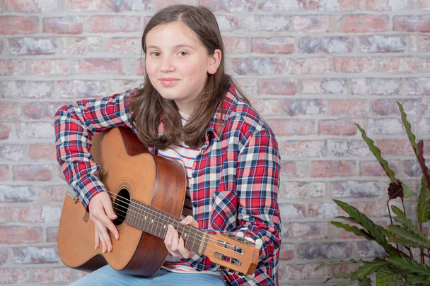 smiling teenager playing guitar - Photo, Image