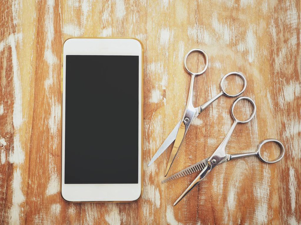 Smart phone with hair cutting shears - Photo, Image