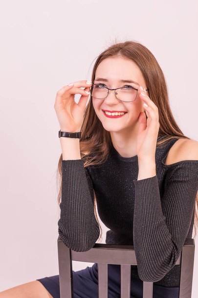 Beautiful girl in black dress with glasses from the Finance Department. From the office. - Zdjęcie, obraz