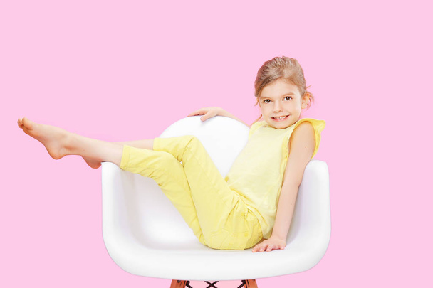 Stylish little girl in yellow n pink - Фото, изображение